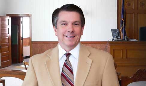 Jeffers smiling at his desk up close photo